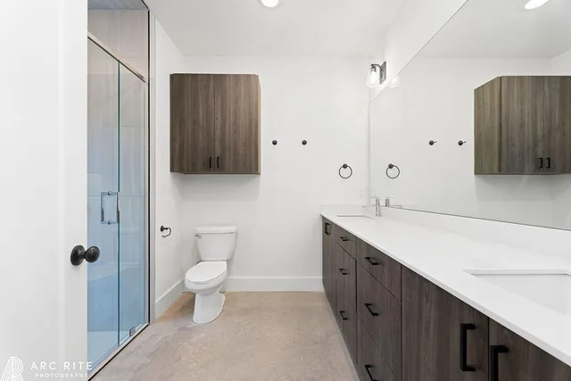 a spacious bathroom with a sink a toilet and shower