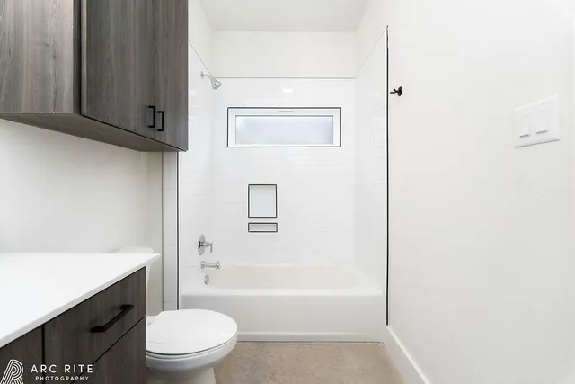a bathroom with a toilet a sink and bathtub
