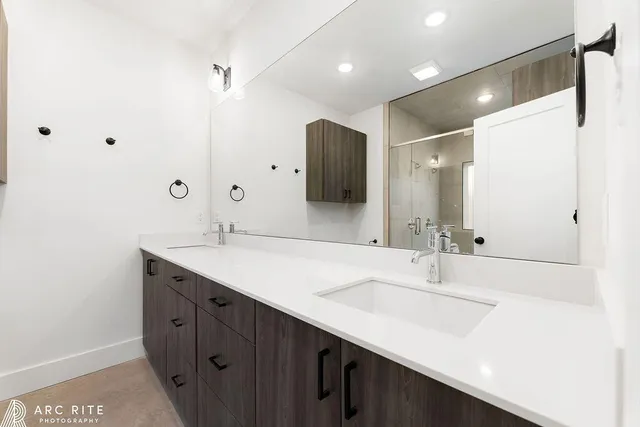 a bathroom with a double vanity sink and a mirror