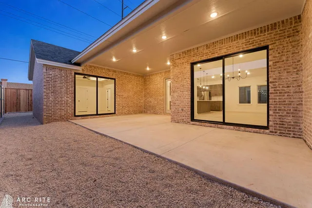 a view of an empty room with a fireplace and a large window