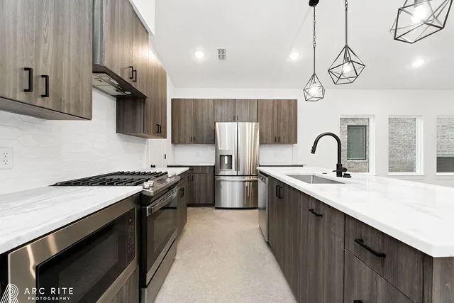 a kitchen with a sink stove and refrigerator