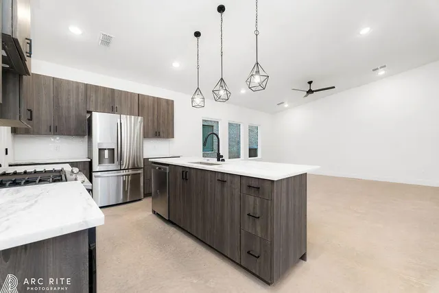 a kitchen with refrigerator cabinets and stove