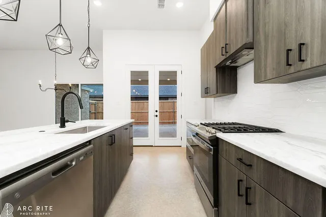 a kitchen with a sink stove and microwave