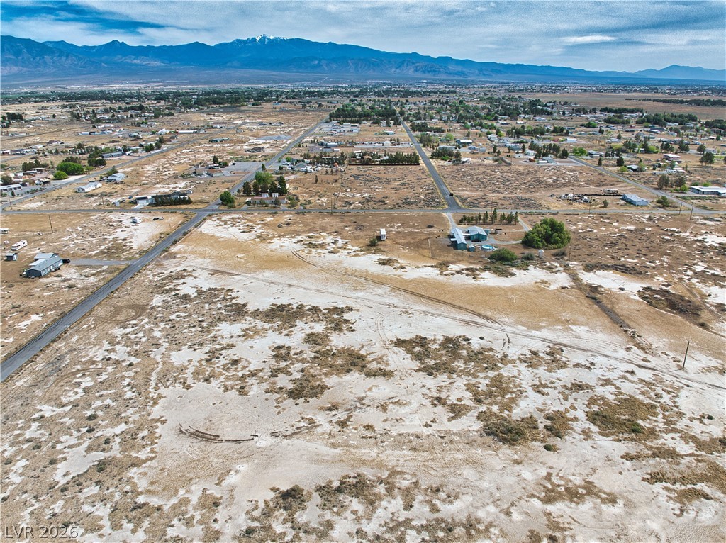 3591 West Wilson Road Pahrump, NV 89048 - Photo 11 of 12 View of property location featuring a mountain backdrop, rural landscape, and nearby suburban area