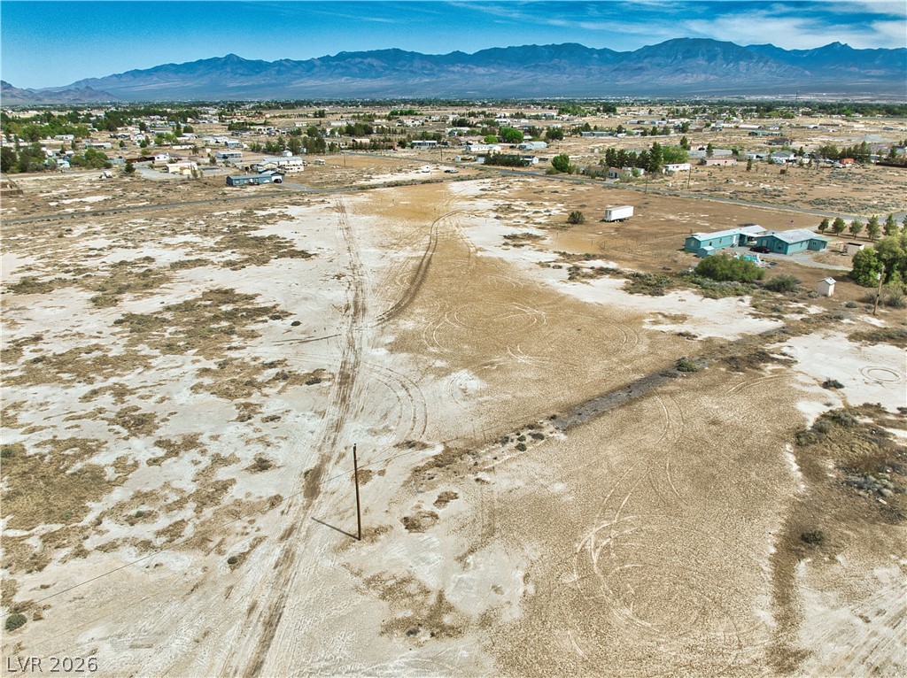 3591 West Wilson Road Pahrump, NV 89048 - Photo 5 of 12 Aerial view of sparsely populated area featuring a mountainous background and nearby suburban area