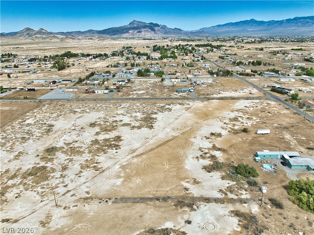 3591 West Wilson Road Pahrump, NV 89048 - Photo 9 of 12 Aerial view of property's location featuring mountains, nearby suburban area, and rural landscape