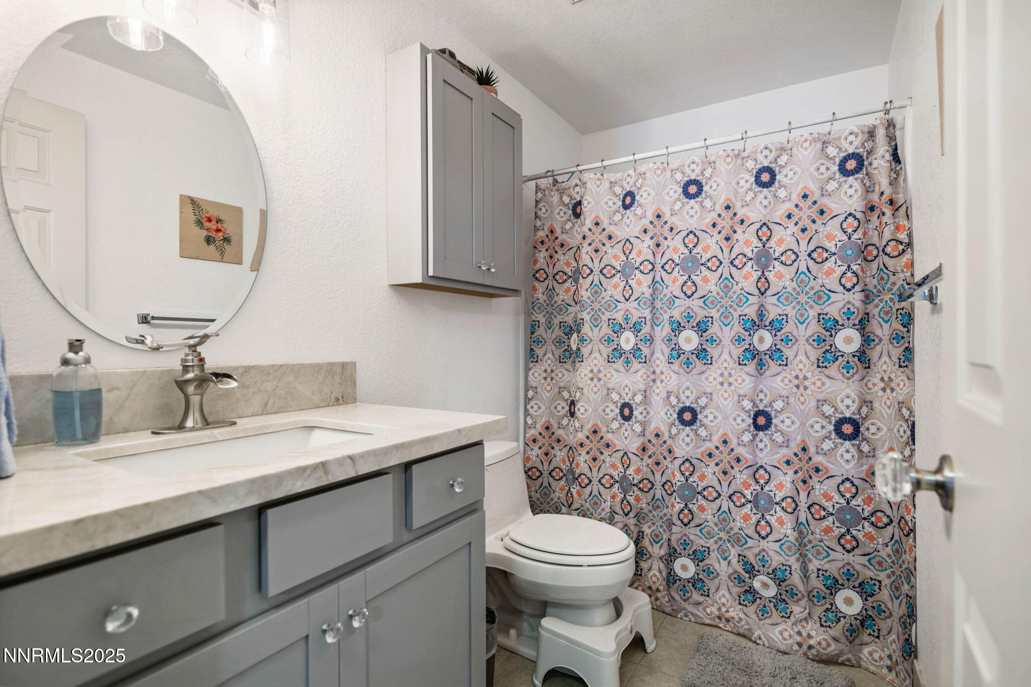 3574 Haystack Drive Carson City, NV 89705 - Photo 28 of 39 a bathroom with a granite countertop sink a toilet and a mirror