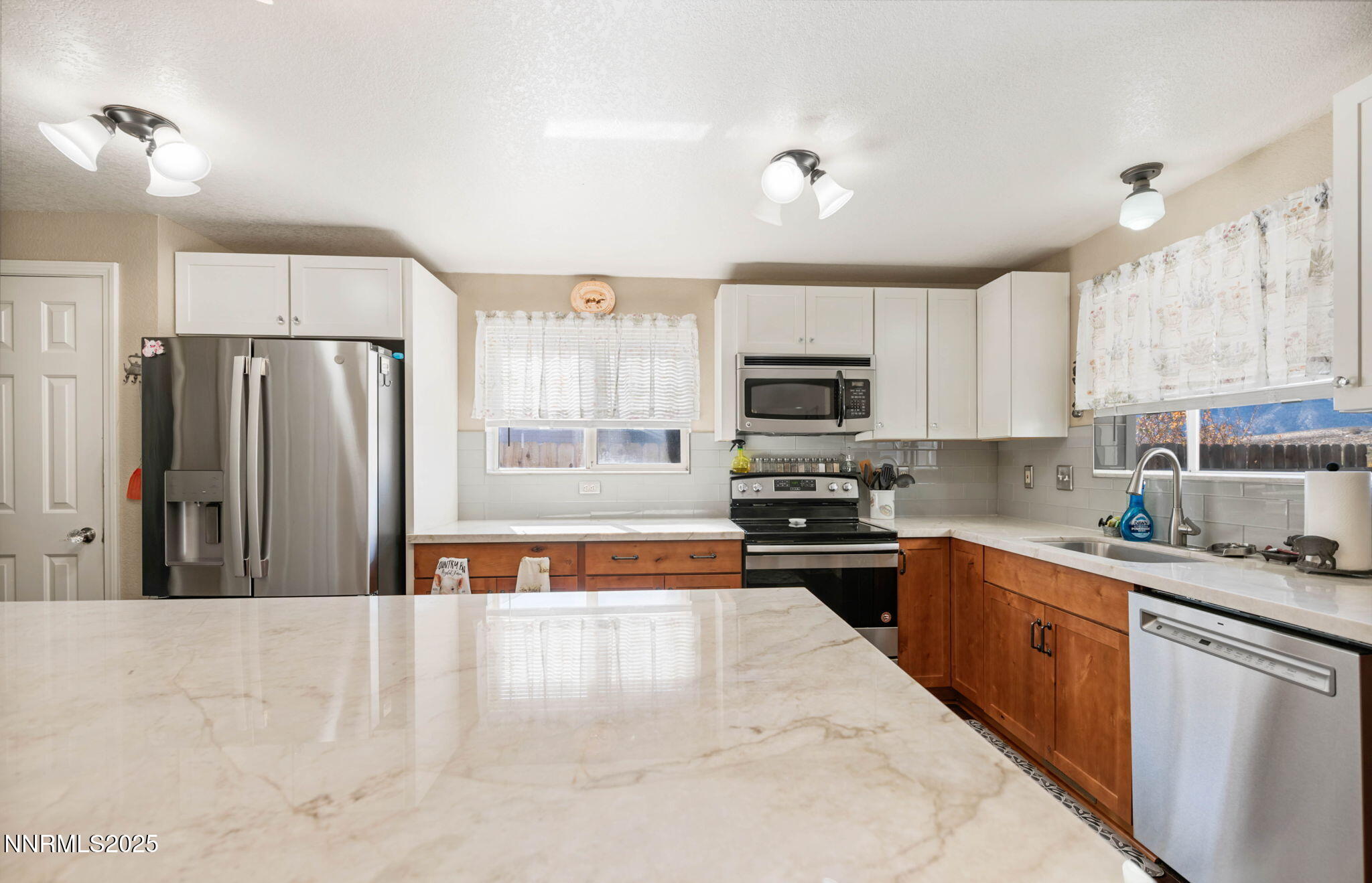 3574 Haystack Drive Carson City, NV 89705 - Photo 10 of 39 a kitchen with stainless steel appliances granite countertop a refrigerator a sink dishwasher a stove oven and white countertops with cabinets