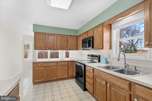 a kitchen with a sink stove and microwave