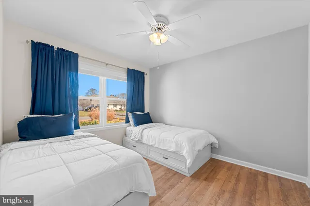 a bedroom with two beds and a chandelier