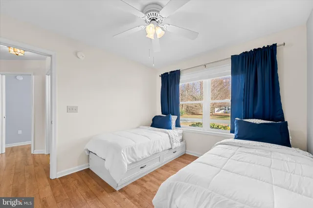 a bedroom with two beds and a window