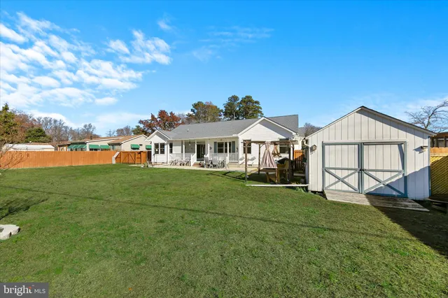 a backyard of a house with table and chairs