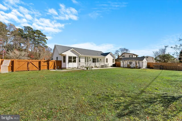 a front view of a house with a yard porch and seating area
