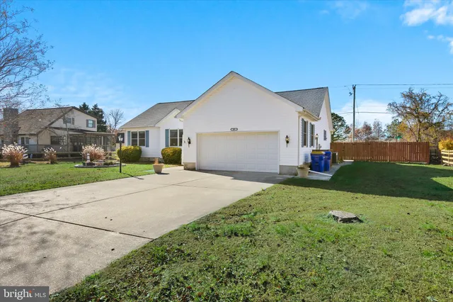 a view of house with garden space and trees