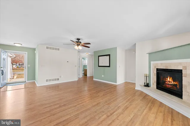 a view of an empty room with window and fire place