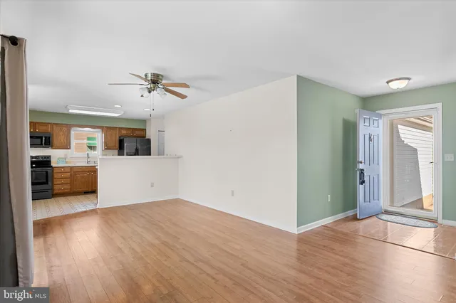 a view of a kitchen with a sink a kitchen counter space and wooden floor