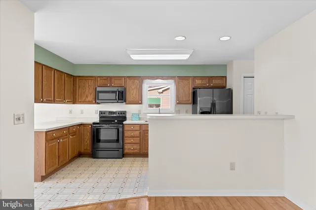 a kitchen with stainless steel appliances granite countertop a stove top oven a sink and dishwasher