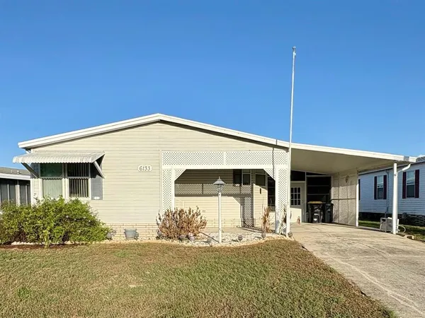 a view of a house with a yard and garage