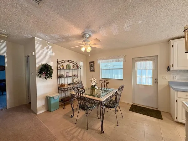 a view of a dining room with furniture and chandelier