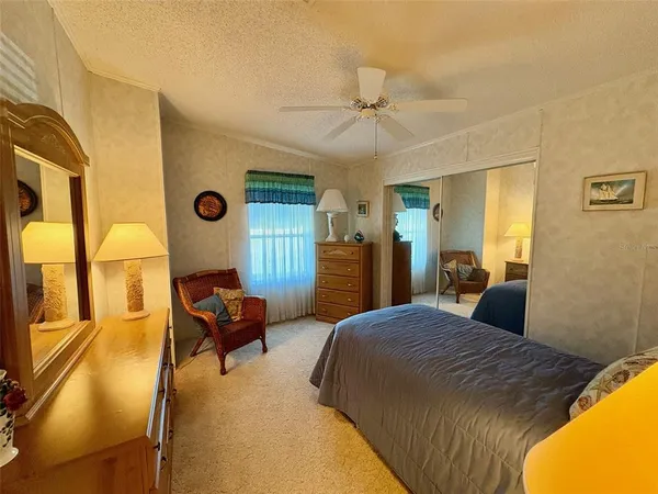 a bedroom with a bed and lamp