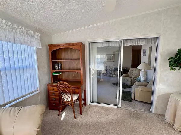 a living room with furniture and a gym equipment