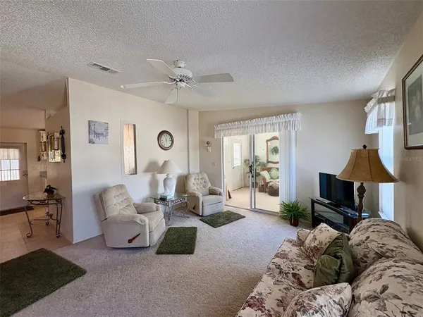 a living room with furniture a couch and a window