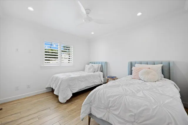 a bedroom with two beds and a table