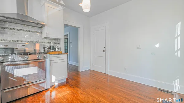 a view of a kitchen with wooden floor
