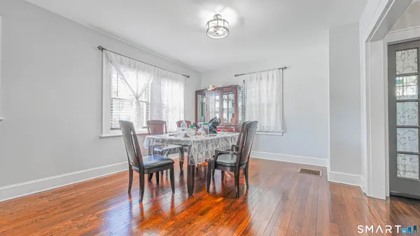 a view of a dining room with furniture and wooden floor