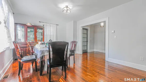 a view of a dining room with furniture and wooden floor
