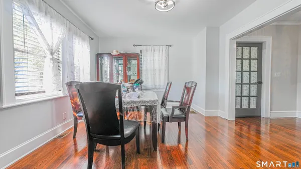 a view of a dining room with furniture and wooden floor