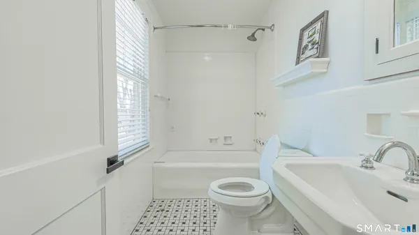 a bathroom with a sink a toilet and a bathtub