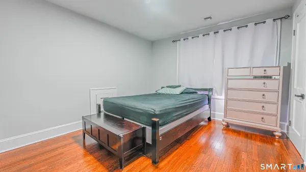 a room with a bed and a dresser