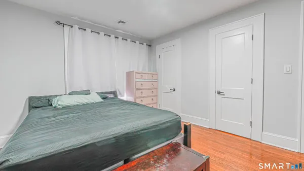 a bedroom with a bed and a dresser