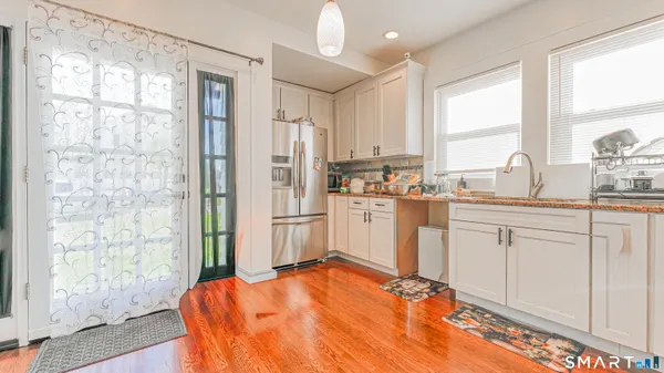 a kitchen with white cabinets and white appliances