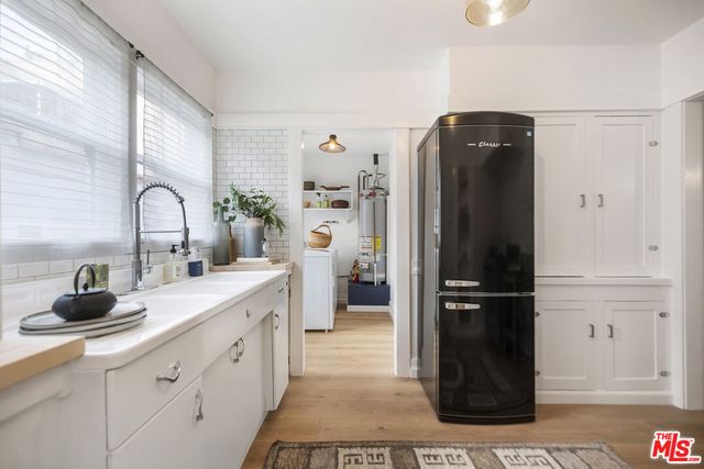 a kitchen with a refrigerator and a sink
