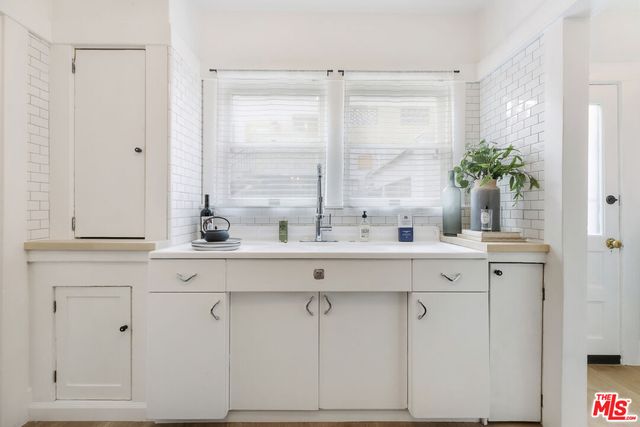 a bathroom with a sink and mirror