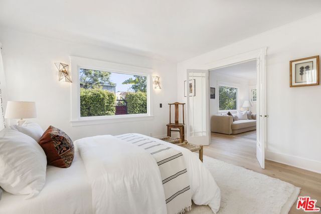 a bedroom with a large bed and a large window