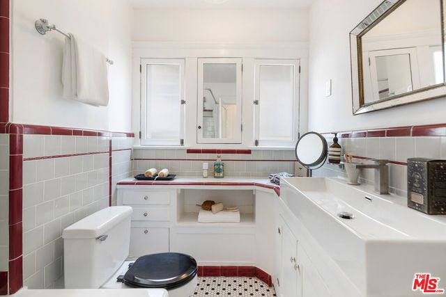 a bathroom with a sink a toilet and vanity