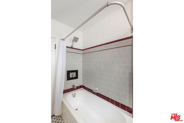 a bathroom with a tub and shower