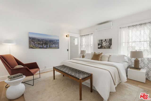 a spacious bedroom with a bed and window