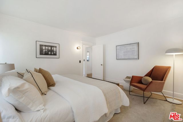 a bedroom with a bed and chair