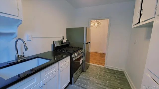 a kitchen with granite countertop a stove and a refrigerator