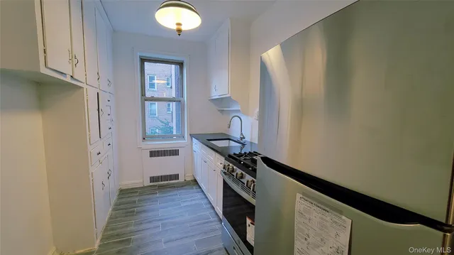 a kitchen with a refrigerator and a stove