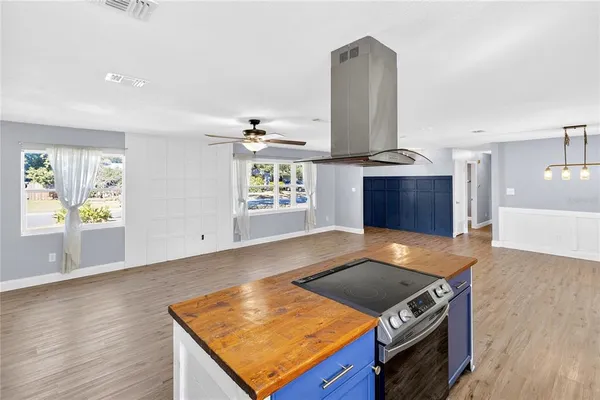 a kitchen with stainless steel appliances granite countertop a stove a sink and a microwave