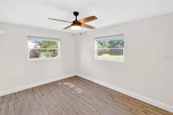 a view of empty room with wooden floor