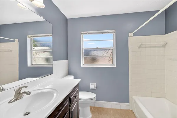 a bathroom with a sink a toilet and tub