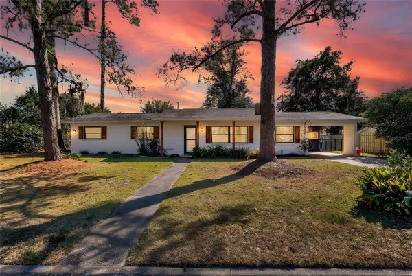 a view of a house with yard and tree s