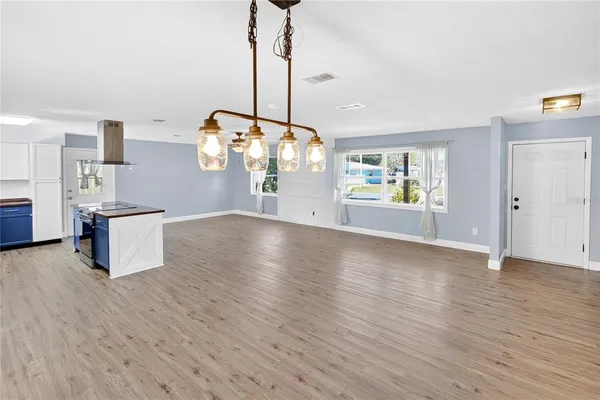 a view of a kitchen with a wooden floor and a window