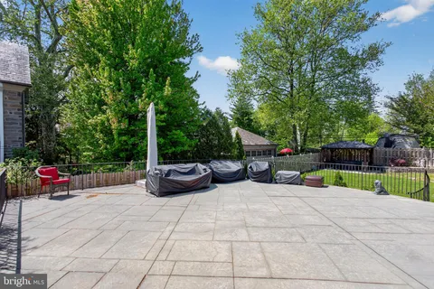 a kitchen with stainless steel appliances granite countertop wooden cabinets a sink a stove and a window